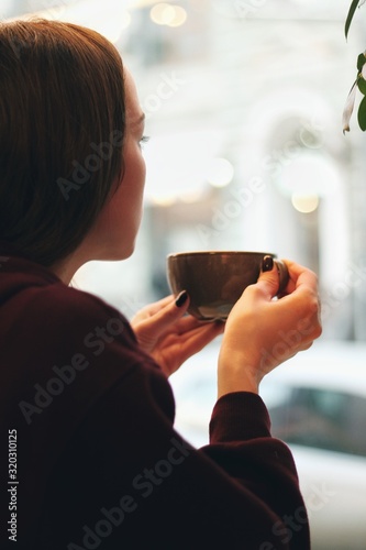 Obraz na płótnie Caucasian young woman enjoying coffee drinking in cafe, close up w salonie