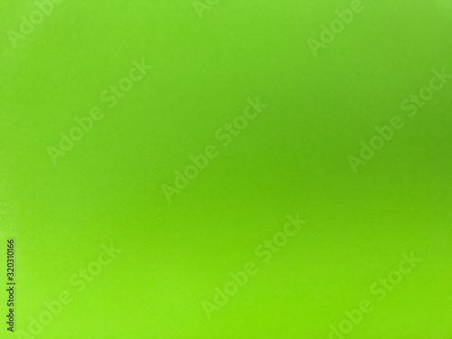 Colorful background, blurred green color on uneven surface, colored spots on materials