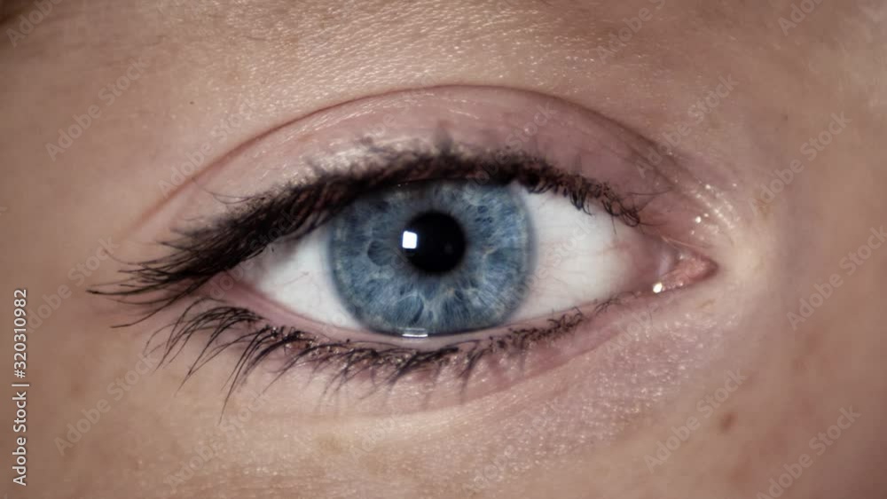 Blue eye of a woman girl looking directly into camera. Blue eye of a woman girl looking directly into camera.