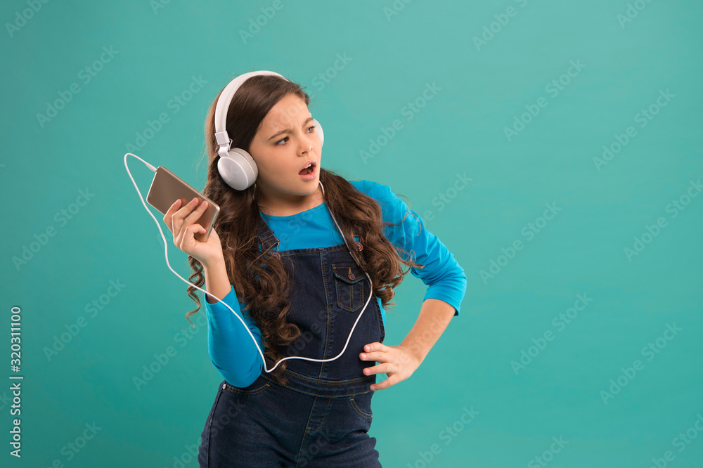 small girl use mp3 player. study in modern life. schoolgirl use digital  device. casual fashion for