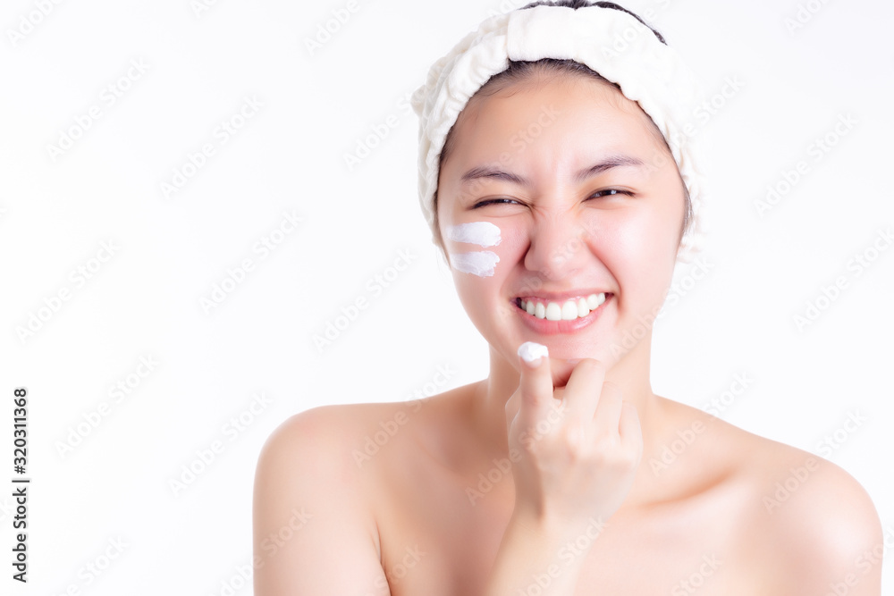 Asian woman apply cream, lotion to beautiful skin on face, smile face. Young woman show cream, apply moisturizer on face. Asia beauty girl get happiness. She has nice skin. Skincare concept, copyspace Asian woman apply cream, lotion to beautiful skin on face, smile face. Young woman show cream, apply moisturizer on face. Asia beauty girl get happiness. She has nice skin. Skincare concept, copyspace