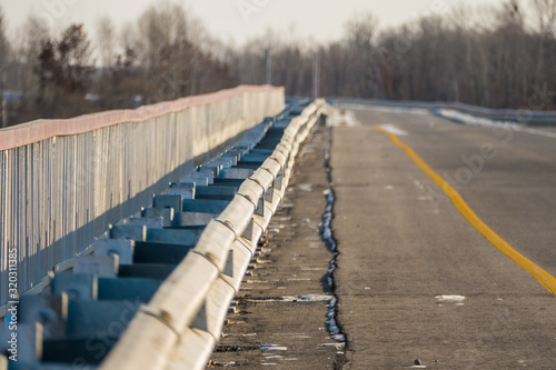 The bridge's metal railings extend into the distance © MFomin