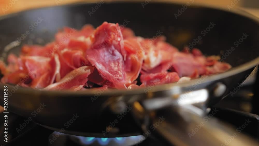 fried ham in a pan close-up macro. fried ham in a pan close-up macro.