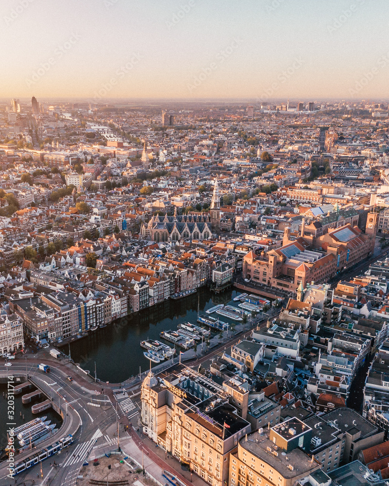 Aerial drone shot of the Skyline of Amsterdam, Netherlands while sunrise