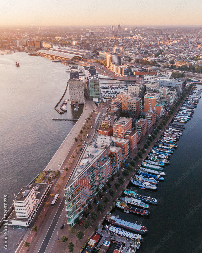 Aerial drone shot of the Westdock in Amsterdam, Netherlands while sunrise