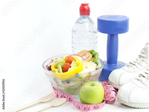Fototapeta Naklejka Na Ścianę i Meble -  Selective focus of Dumbbell and Healthy eating with Workout and fitness dieting ,fitness and weight loss concept on white background