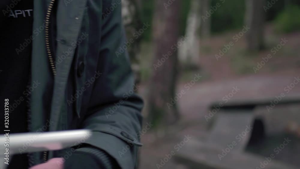 professional drone pilot operating his drone with his white remote for inspection or filmmaking. professional drone pilot operating his drone with his white remote for inspection or filmmaking.