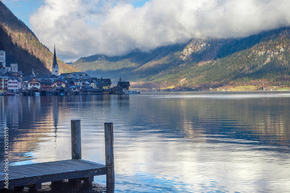 Hallstatt, a charming village on the Hallstattersee lake and a famous tourist attraction, with beautiful mountains surrounding it, in Salzkammergut region, Austria, in winter sunny day.