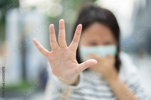 Woman wearing face mask protect filter against air pollution (PM2.5) or wear N95 mask. protect pollution, anti smog and viruses, Air pollution caused health problem. environmental pollution concept. © zasabe