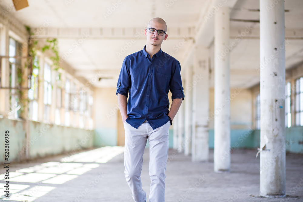 Cute, young man in blue shirt and white pants with eyeglasses. Teen fashion Cute, young man in blue shirt and white pants with eyeglasses. Teen fashion