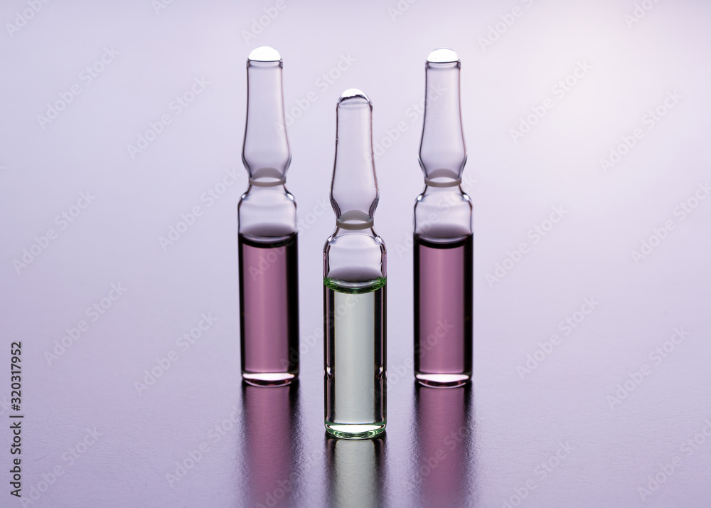 Medical ampoules close up. Many ampoules. Glass ampoules on the table. Scattered ampoules with medicine. Medical ampoules close up. Many ampoules. Glass ampoules on the table. Scattered ampoules with medicine.