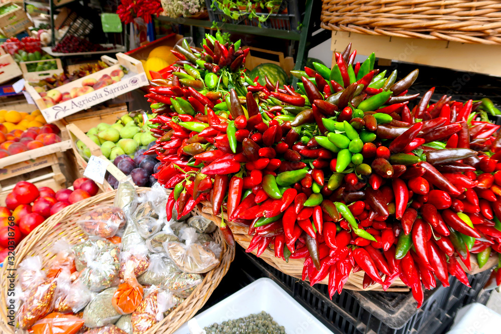 Chillies, red chilli pepper, on the traditional italian fruit, vegetable and spice market in Gallipoli town, Italy, Apulia region, Adriatic Sea