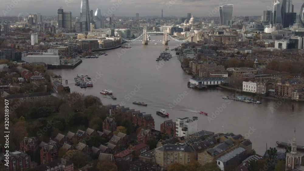 Aerial pan up of central London and the River Thames including Tower Bridge, the City of London, the Shard, the London Eye, BT Tower, ST Paul's Cathedral Aerial pan up of central London and the River Thames including Tower Bridge, the City of London, the Shard, the London Eye, BT Tower, ST Paul's Cathedral