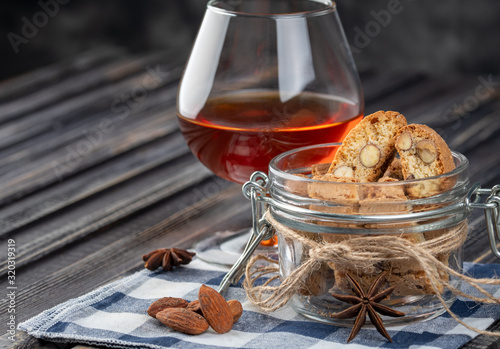 Traditional italian Christmas New Year dry cookies biscuits biscotti cantuccini. Biscotti di Prato with dessert wine.
