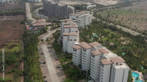 Tilt Up Aerial View of Upscale Condos, Tropical Vegetation and Coastline of Acapulco, Mexico photo