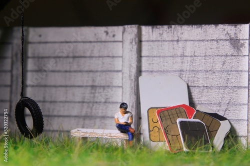 Illustration for Communication Technology Article Related, Man Sitting at white wooden chair, beside stack of SIM Card at yard,   © Tutik