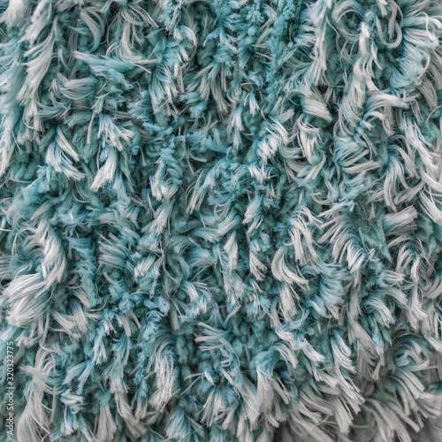 Turquoise white shaggy faux long fur close up