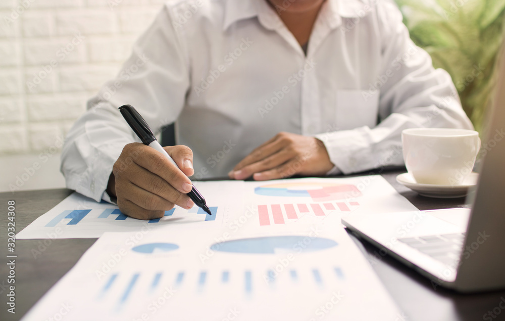 business man or banker checking profit finance graph on table business man or banker checking profit finance graph on table