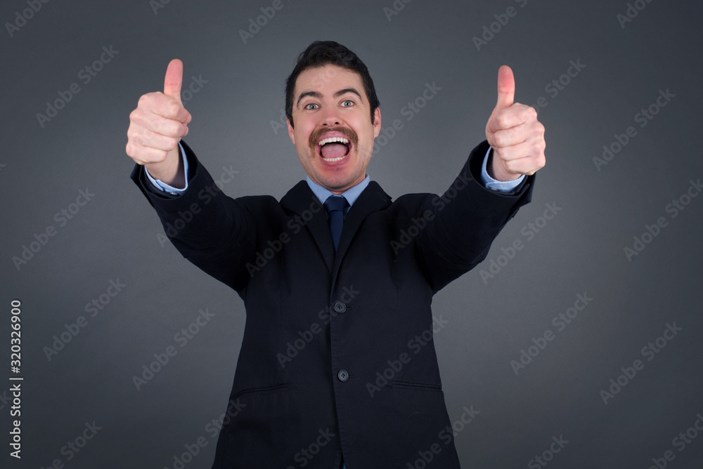 Good job! Portrait of a happy smiling businessman giving two thumbs up gesture standing indoors. Positive human emotion facial expression body language. Funny girl Good job! Portrait of a happy smiling businessman giving two thumbs up gesture standing indoors. Positive human emotion facial expression body language. Funny girl