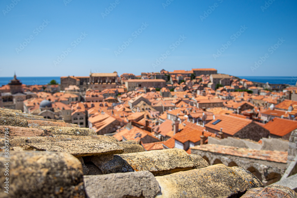 A close up photograph of a buildings terracotta roof in Dubrovnik, Croatia. The background is blurred showing other buildings within the Unesco World Heritage Site.
