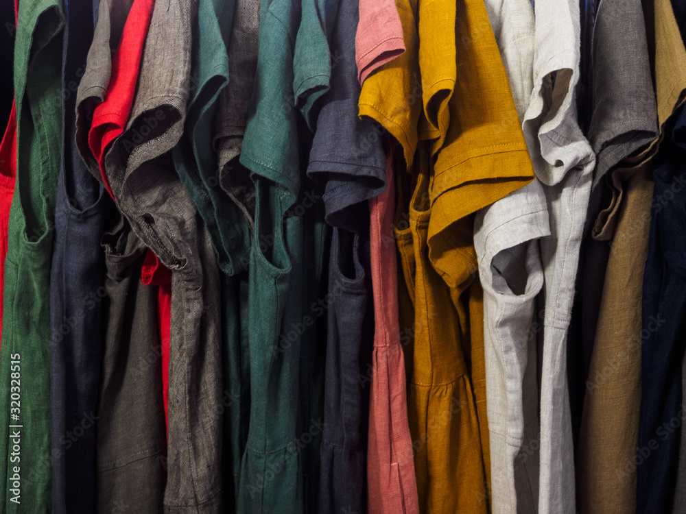 Different things made of natural fabric hang on hangers in the store