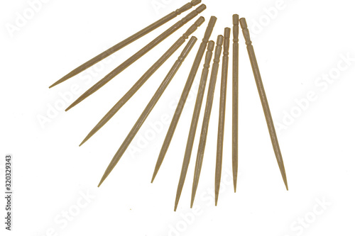 wooden toothpicks scattered on a white background