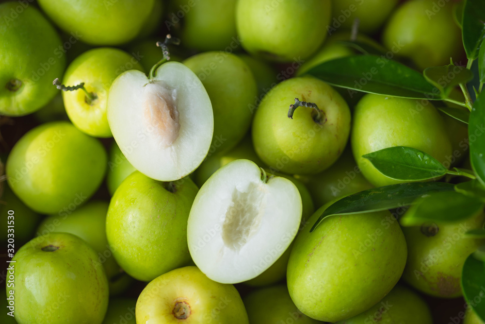 Indian jujubes in basket on table.Chinese date.Fresh jujubes. Fresh and delicious Indian jujube fruit with cut pulp. Jujube seed with wood background.