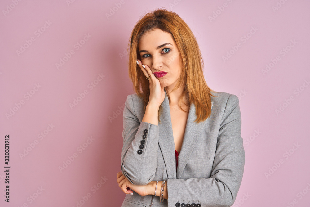 Young caucasian business woman wearing a suit over isolated pink background thinking looking tired and bored with depression problems with crossed arms. Young caucasian business woman wearing a suit over isolated pink background thinking looking tired and bored with depression problems with crossed arms.