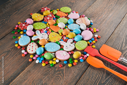 Colorful easter cookies and spatulas on table.