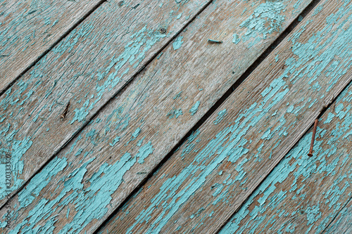 Old turquoise wooden board with rusty hobnails. vintage background