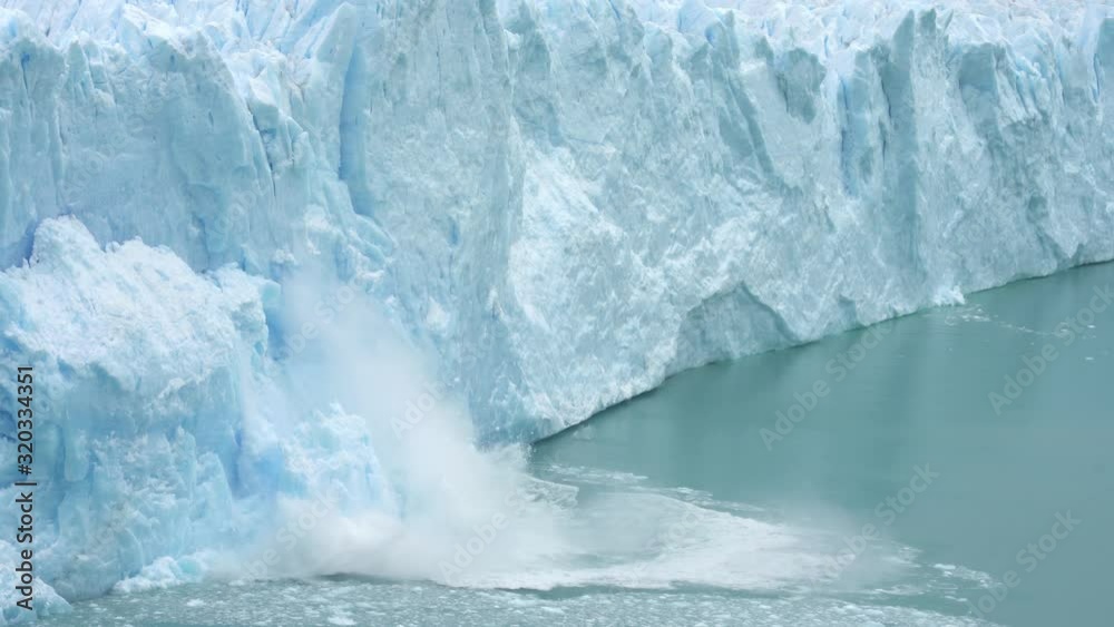 Ice Collapse From Glacier Into Lake. Climate Change and Global Warming Concept Ice Collapse From Glacier Into Lake. Climate Change and Global Warming Concept