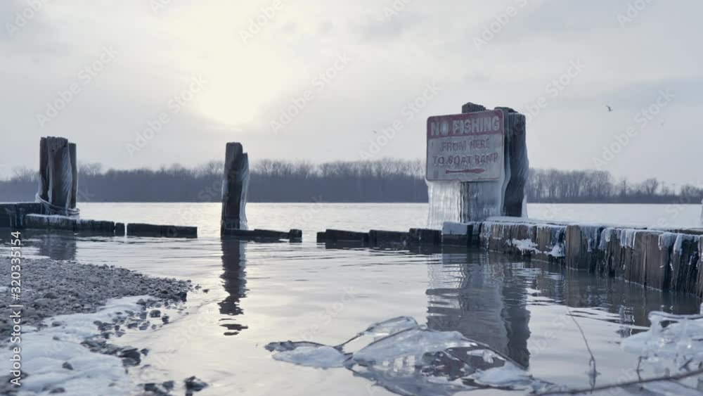 Low angle view lakeside, no fishing prohibition sign, Winter landscape Low angle view lakeside, no fishing prohibition sign, Winter landscape