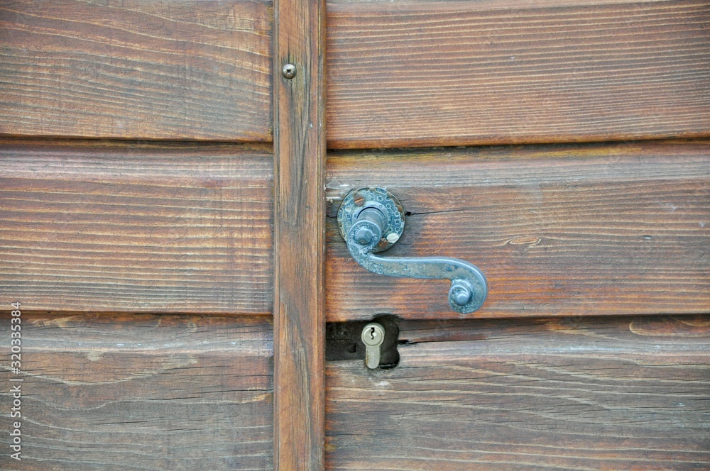 Wooden brown door detail. Old door with ruined lock Wooden brown door detail. Old door with ruined lock