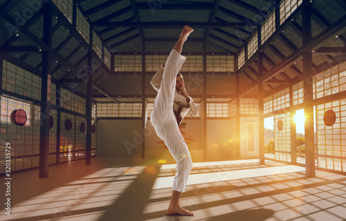 Karate fighters on tatami at sunrise. Japanese hall.