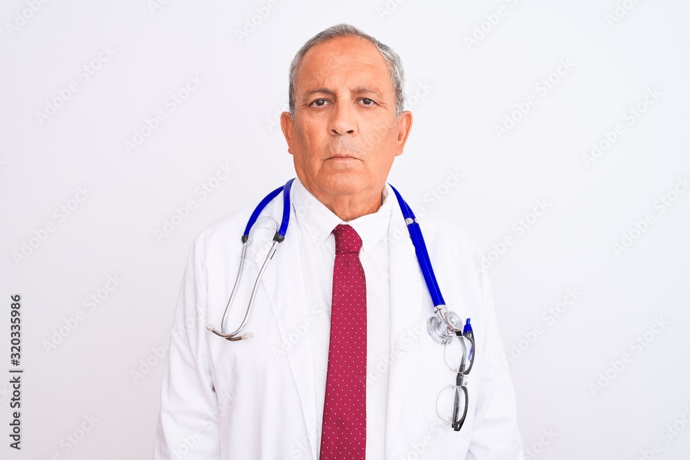 Senior grey-haired doctor man wearing stethoscope standing over isolated white background Relaxed with serious expression on face. Simple and natural looking at the camera. Senior grey-haired doctor man wearing stethoscope standing over isolated white background Relaxed with serious expression on face. Simple and natural looking at the camera.