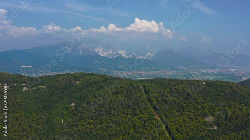 Aerial pull in shot revealing the Apuan Alps and the amazing Carrara white marble quarry photo