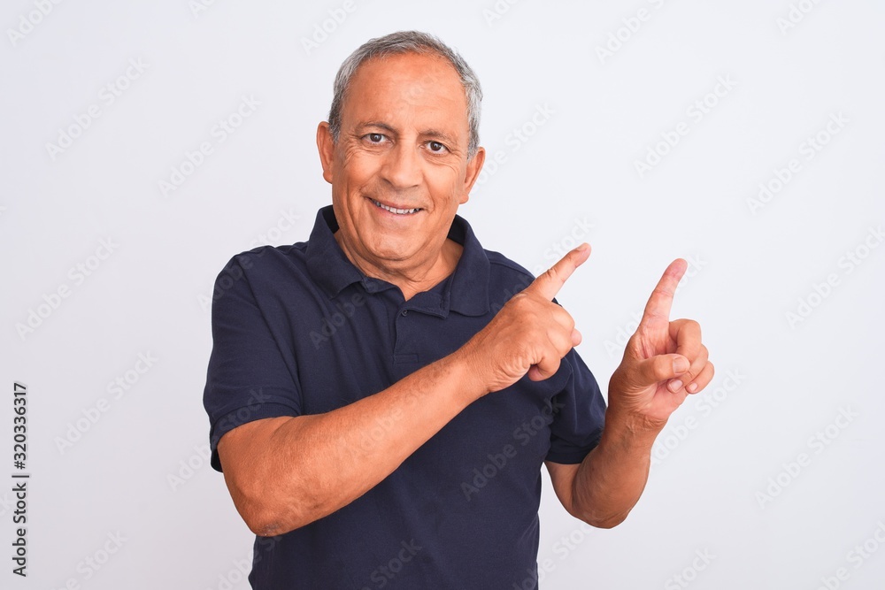 Senior grey-haired man wearing black casual polo standing over isolated white background smiling and looking at the camera pointing with two hands and fingers to the side. Senior grey-haired man wearing black casual polo standing over isolated white background smiling and looking at the camera pointing with two hands and fingers to the side.