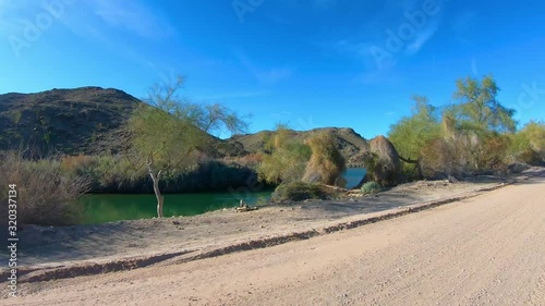 POV driving on dirt road along Irrigation Canal - Yuma Arizona