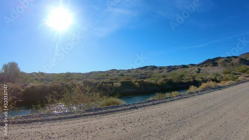 POV driving on dirt road along Gila Gravity Irrigation Canal - Yuma Arizona