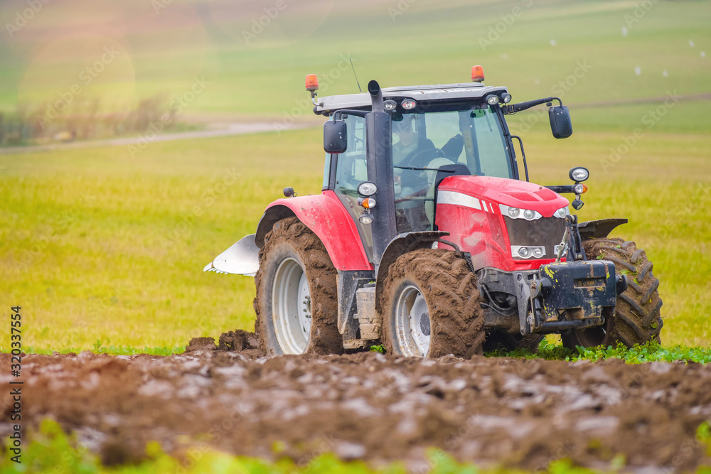 Fototapeta premium farmer plowing his fields in early spring