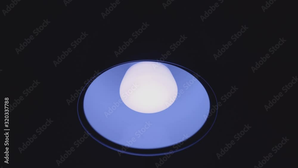 Smart LED bulb cycles through all colors at a slow pace, black background // Static Shot Smart LED bulb cycles through all colors at a slow pace, black background // Static Shot