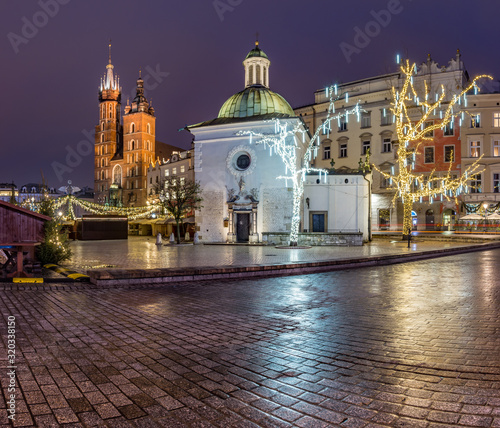 Krakow, Poland, Main Square, Sw Wojciech church and St Mary's church in the winter season, during Christmas fairs