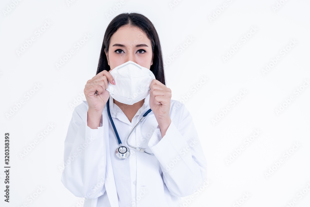 Portrait images of Asian woman doctor holding a mask with white background, concept to health care and primary disease prevention, such as PM 2.5 and coronavirus Portrait images of Asian woman doctor holding a mask with white background, concept to health care and primary disease prevention, such as PM 2.5 and coronavirus