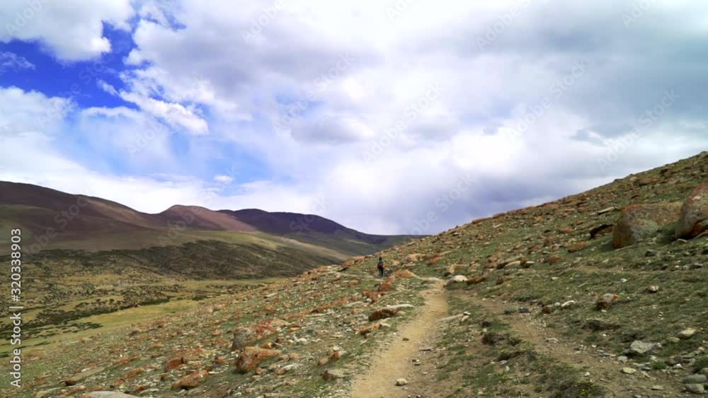 Point of view shot as walking on a mountain trail, road behind another hiker. Point of view shot as walking on a mountain trail, road behind another hiker.