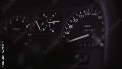 JDM car speedometer closeup with moving light in the dark photo