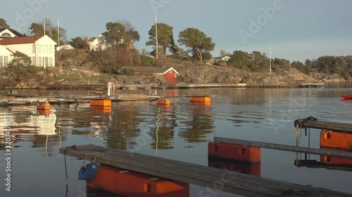 A kayak returning to the harbor in Grimstad, Norway after a paddling tour in mid-winter photo