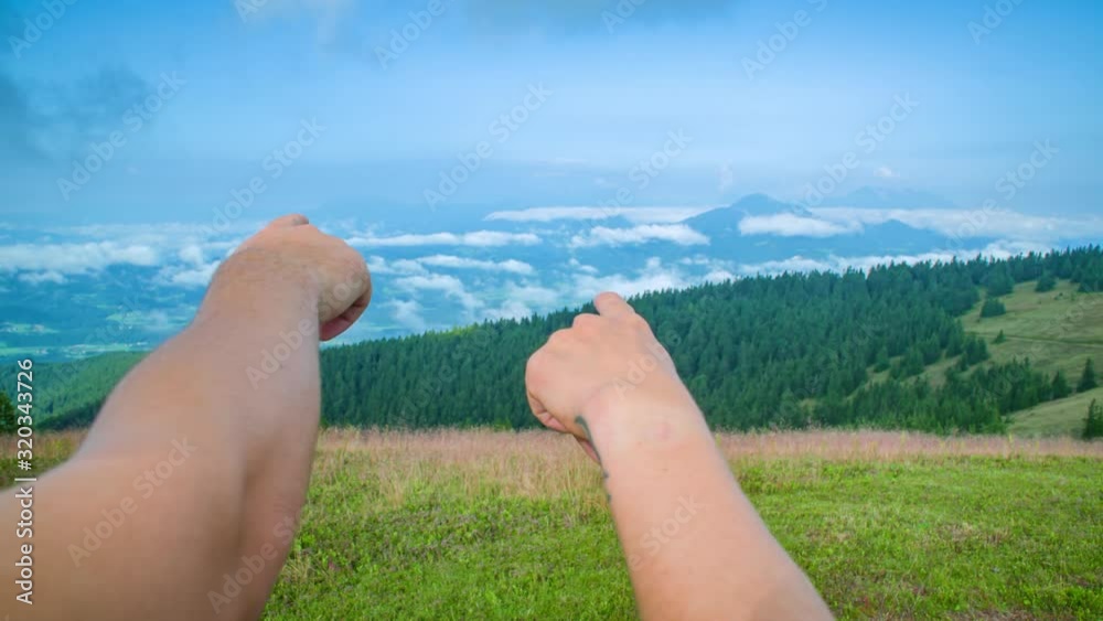 Close up shot of two hikers pointing out the mountain landscape with their fingers. Slow motion Close up shot of two hikers pointing out the mountain landscape with their fingers. Slow motion