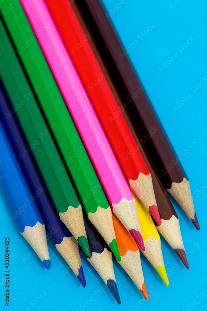 Multi color pencils on a blue background. School concept Multi color pencils on a blue background. School concept