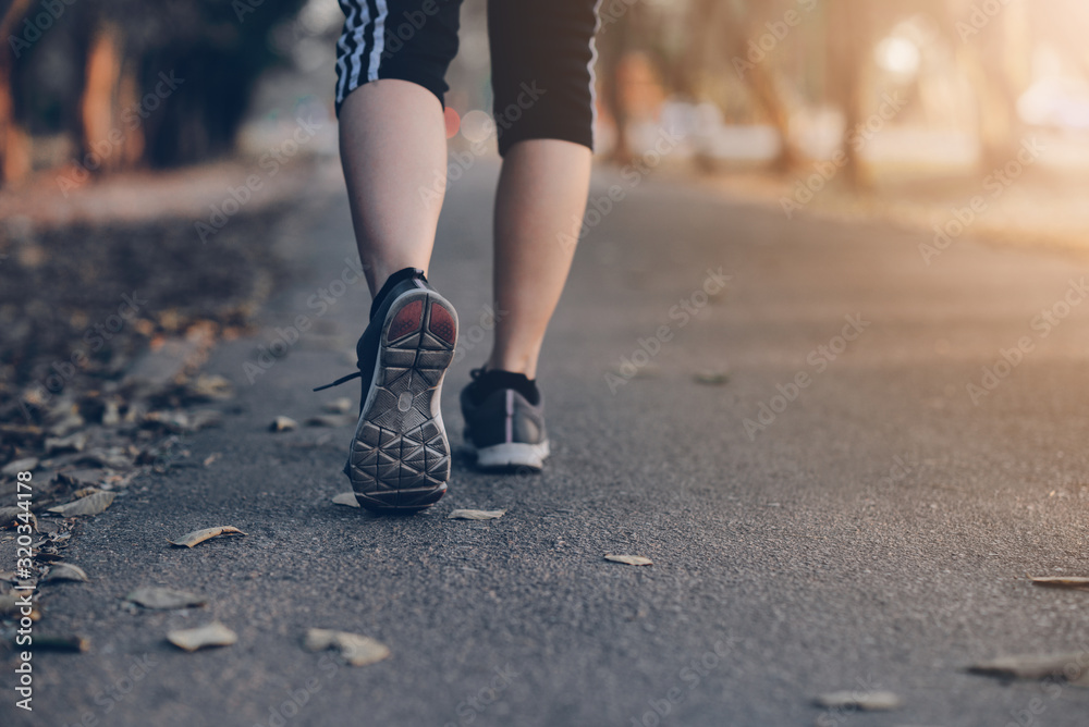 Human running on the park with Close up shoes Human running on the park with Close up shoes