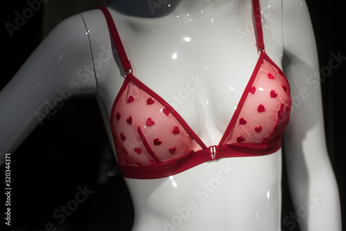 closeup of red bra with little hearts on mannequin in a fashion store showroom